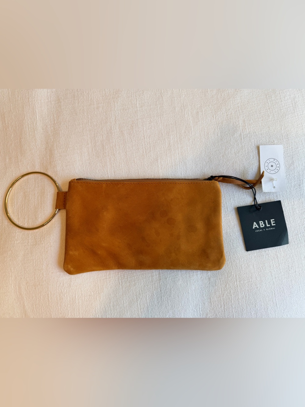 ABLE leather Wristlet Pouch in Cognac Brown with gold ring for wrist